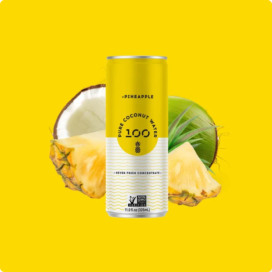 A 100 Coconuts pineapple can beside a cut pineapple and coconut, on yellow.