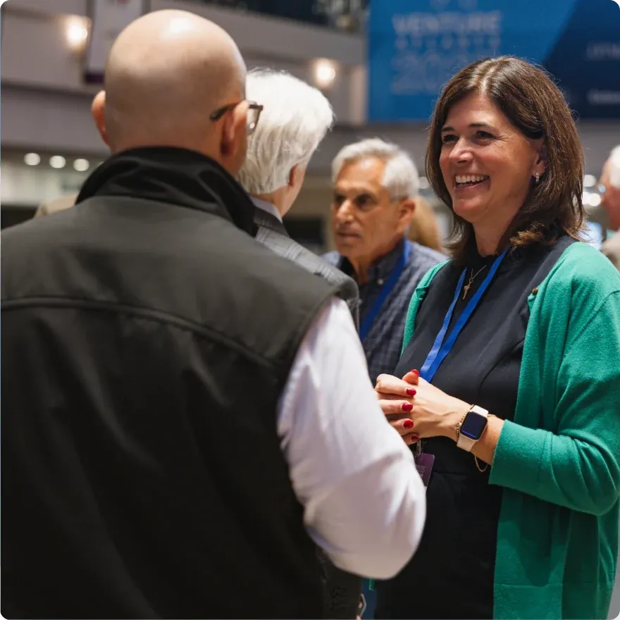 Attendees in conversation on the Venture Atlanta conference floor.