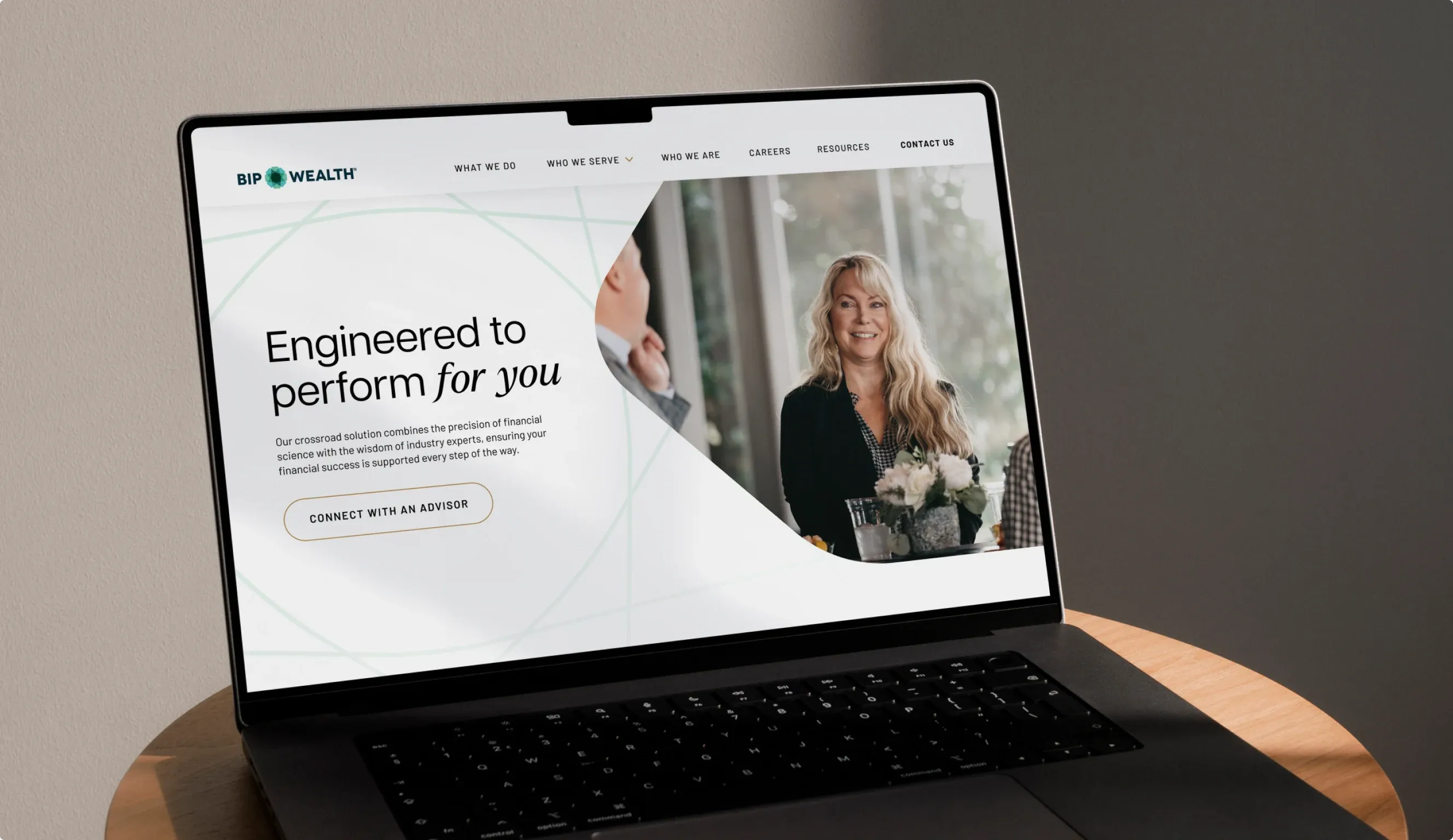 The BIP Wealth home page on a laptop, "Engineered to perform for you" beside a smiling advisor.