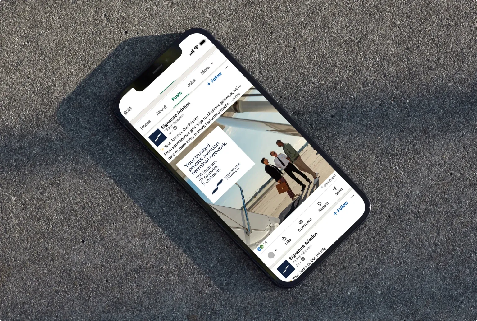 A phone lying on concrete, open on a Signature Aviation post in the LinkedIn feed.