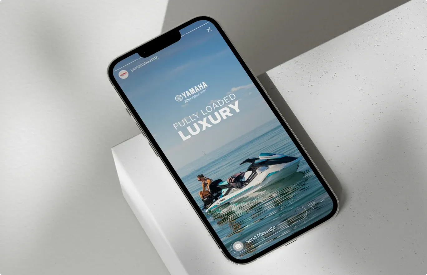 A phone on a white plinth showing the Fully Loaded Luxury WaveRunner ad.