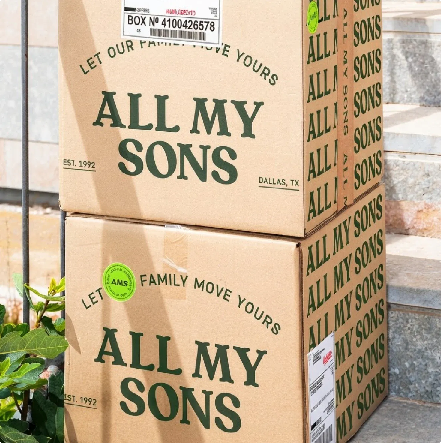 Two stacked All My Sons boxes reading “Let our family move yours” on a front porch.